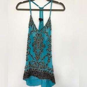Blue sheer top with metal beads embellishments.